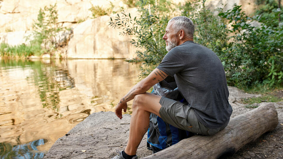 Happy,Middle,Aged,Caucasian,Man,With,Tourist,Backpack,Sitting,On