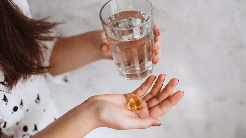 Diet.,Nutrition.,Girl's,Hands,With,Pills,With,Cod,Liver,Omega-3