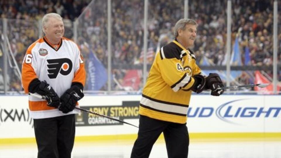 Honorary captains Bobby Clarke, left, of the Philadelphia Flyers, and Bobby Orr of the Boston Bruins meet at center ice before the New Year's Day Winter Classic NHL hockey game on an outdoor rink at Fenway Park in Boston, Friday, Jan. 1, 2010. (AP Photo/Elise Amendola)