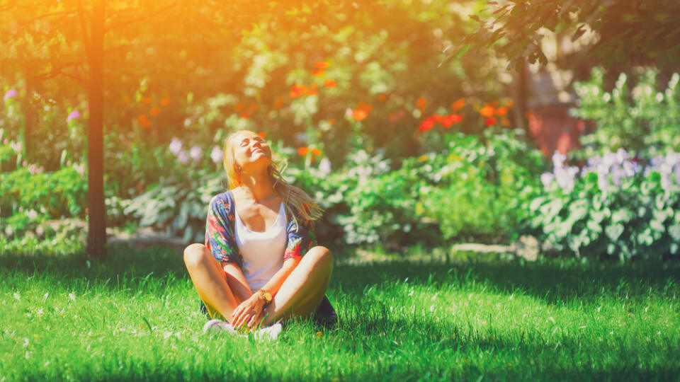 Happy,Free,Young,Woman,Sitting,Outdoors,In,Yoga,Position,With