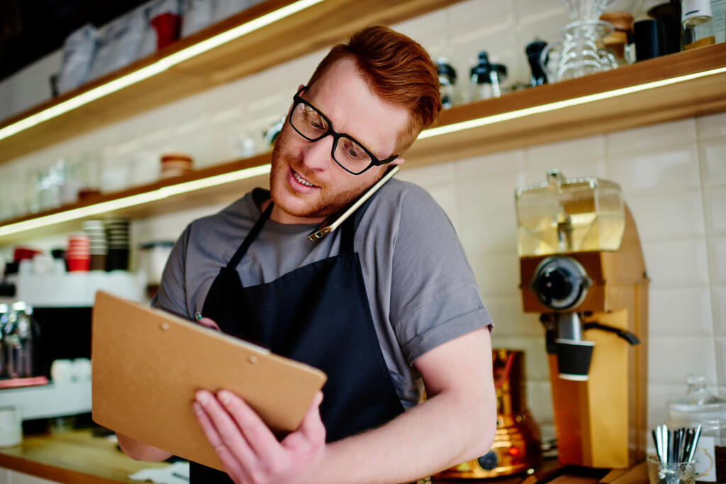 From,Below,Attentive,Employee,In,Glasses,And,Uniform,Concentrating,On