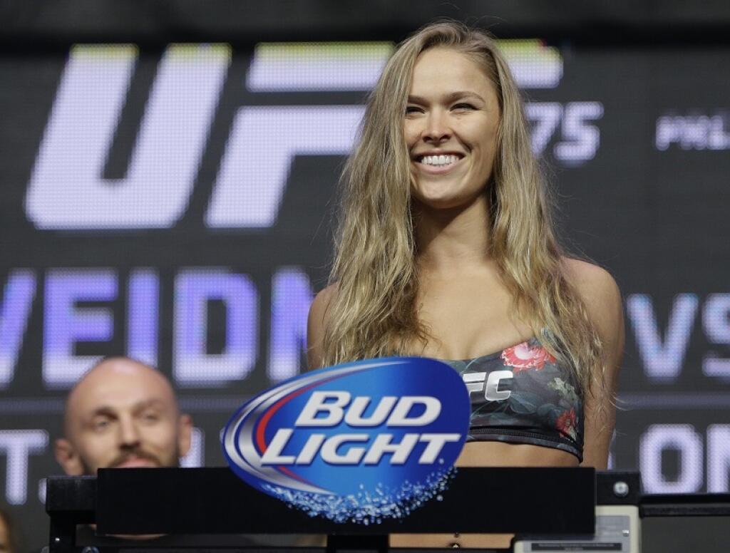FILE - In this July 4, 2014, file photo, Ronda Rousey stands on the scale during a weigh-in for the UFC 175 mixed martial arts event at the Mandalay Bay in Las Vegas. Rousey has dominated every challenger in her two-year reign as the UFC's only women's bantamweight champion. Cat Zingano still believes she has a legitimate shot at Rousey's belt in UFC 184 on Saturday, Feb. 28, 2015, in Los Angeles. (AP Photo/John Locher, File)