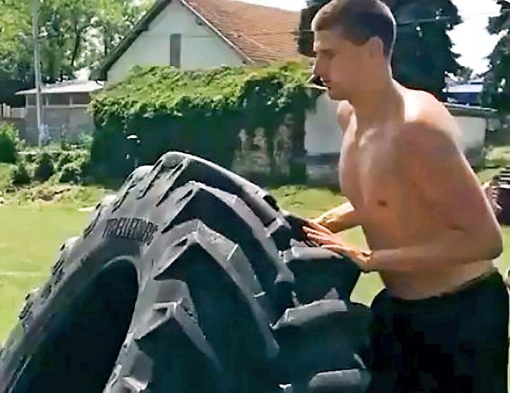 GREAT EFFORT: Nikola Jokic works out madly with Giant Tire to reduce a gallon of soda daily