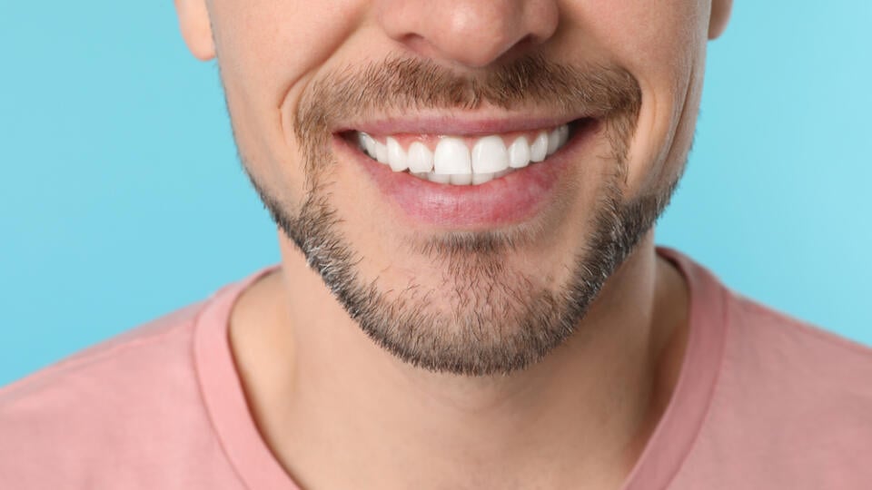 Smiling,Man,With,Perfect,Teeth,On,Color,Background,,Closeup