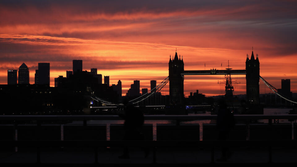 EBE 34 Londýn - Na snímke Tower Bridge a siluety mrakodrapov finančnej štvrte pri východe slnka v Londýne v pondelok 12. októbra 2020. FOTO TASR/AP
Tower Bridge and the skyscrapers of the Canary Wharf financial district, left, are seen at sunrise in London, Monday, Oct. 12, 2020.(AP Photo/Matt Dunham)