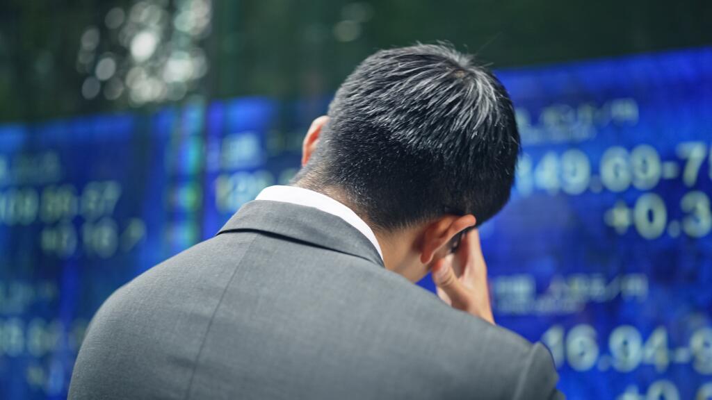 Depressed,Businessman,In,Front,Of,An,Electric,Bulletin,Board.