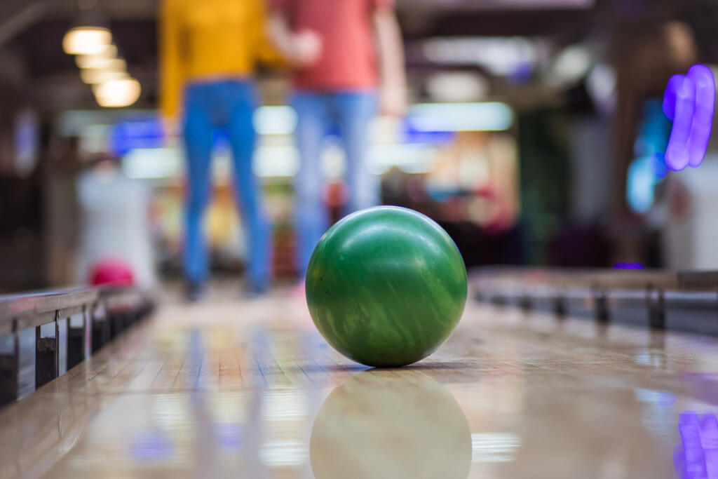 Young,Couple,Having,Fun,In,Bowling,Alley.,Focus,Is,On