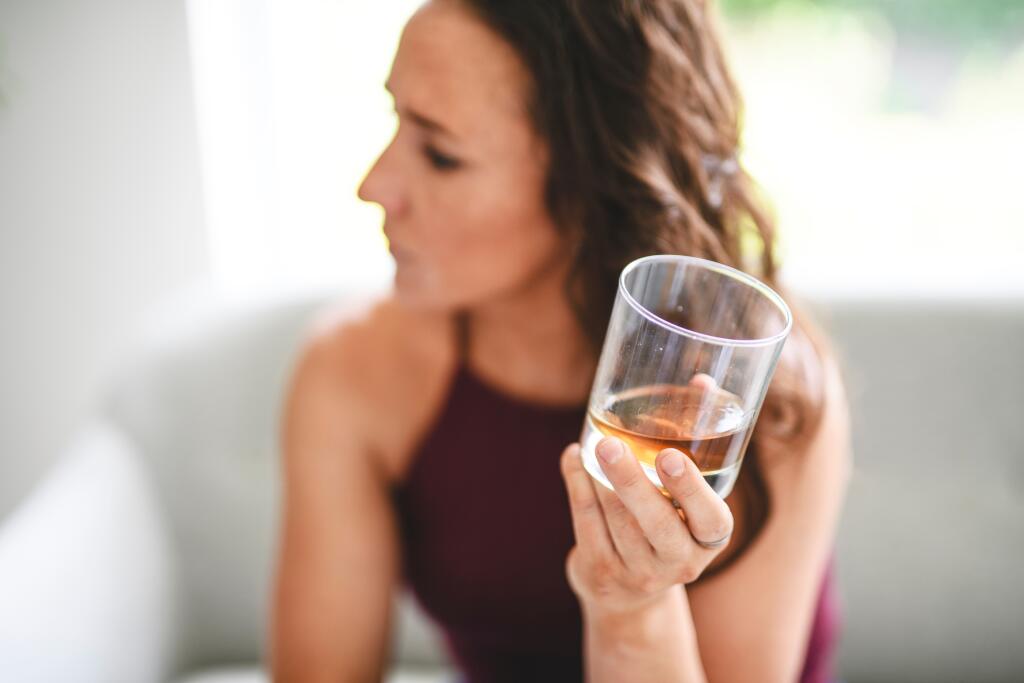 An,Alone,Depressed,Woman,Drink,Booze,On,Sofa,At,Home.
