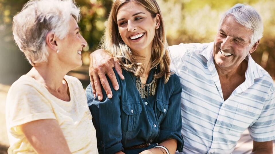 Senior,Parents,In,Nature,With,Their,Adult,Daughter,Sitting,,Talking