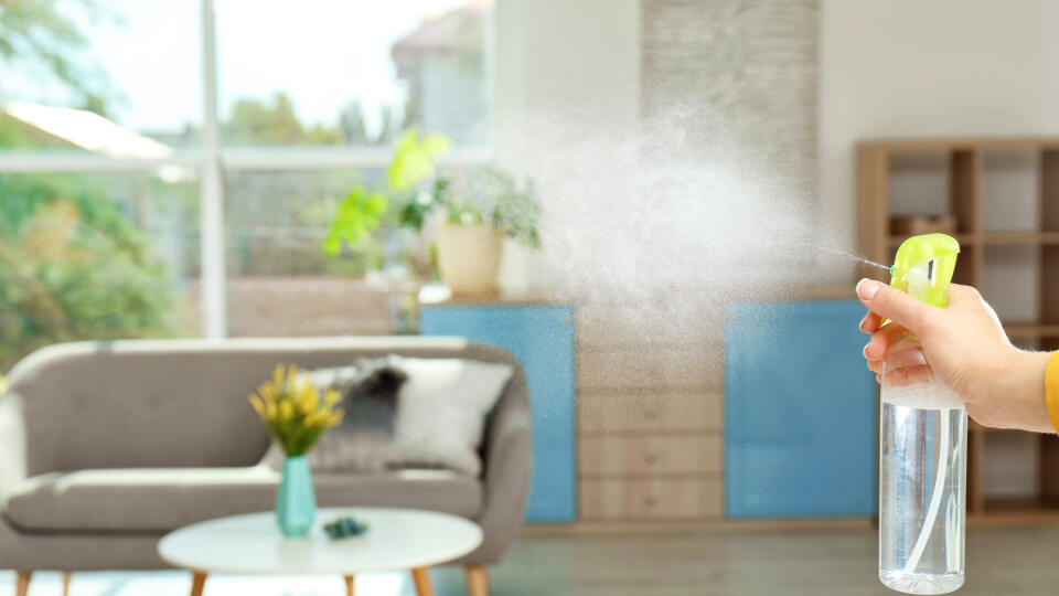 Woman,Spraying,Air,Freshener,At,Home