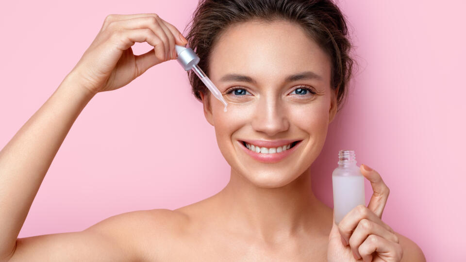 Woman,Applying,Hyaluronic,Serum,On,Her,Face,With,Pipette.,Photo