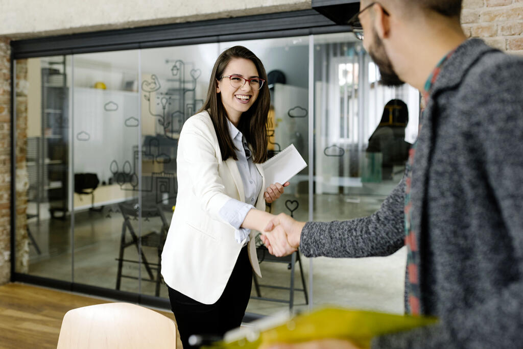 Openly greeting a job recruiter with a firm handshake