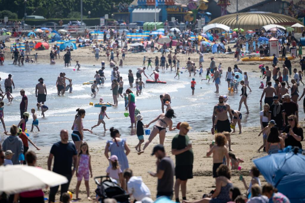Tourists pack a crowded Weymouth beach