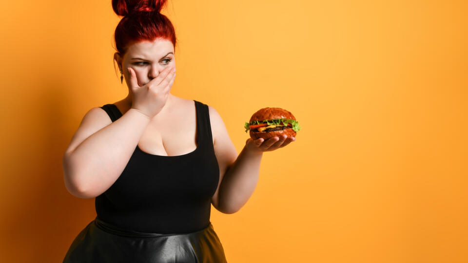 Chubby,Overweight,Fat,Woman,Looks,With,Disgust,At,Burger,Cheeseburger