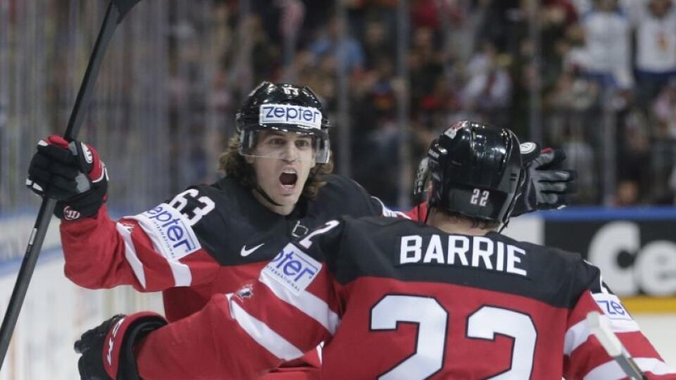 Canada’s Tyler Ennis, left, celebrates with Tyson Barrie, right, the opening goal against Russia, scored by Cody Eakin, during the Hockey World Championships gold medal match in Prague, Czech Republic, Sunday, May 17, 2015. (AP Photo/Petr David Josek)