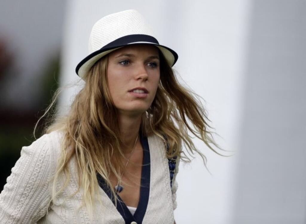 Tennis player Caroline Wozniacki leaves after watching Rory McIlroy, of Northern Ireland, during the first round of the Masters golf tournament Thursday, April 11, 2013, in Augusta, Ga. (AP Photo/David Goldman)