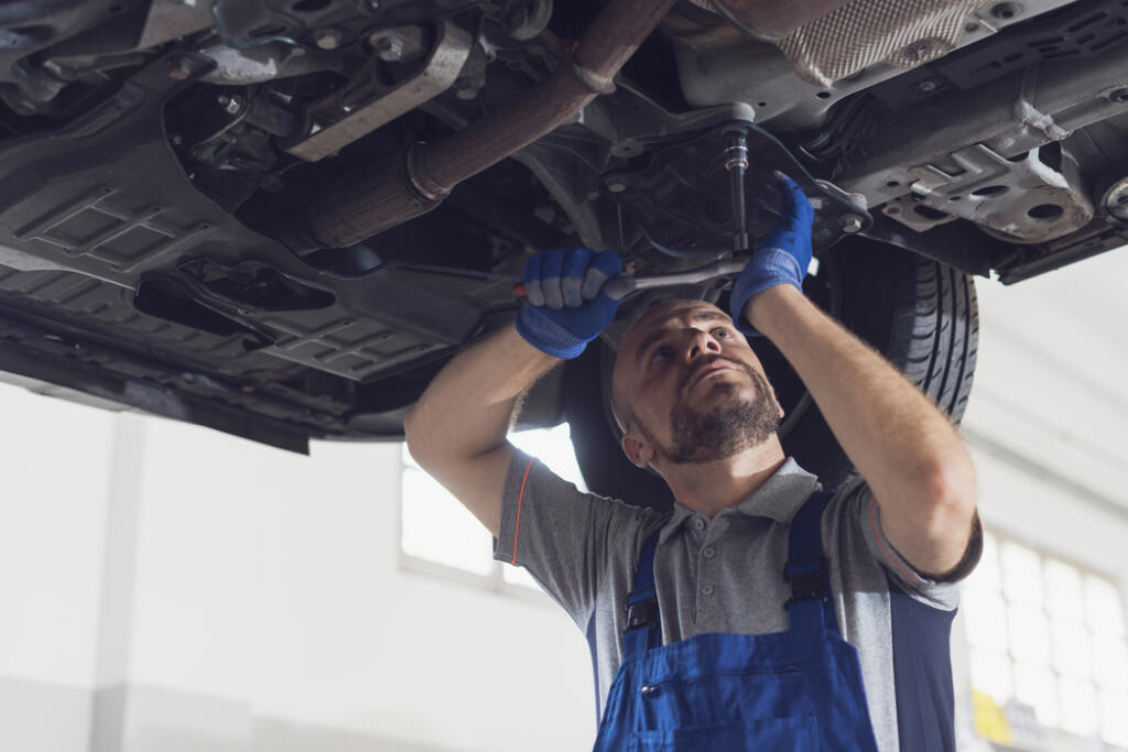 Professional,Mechanic,Working,Under,A,Car,,He,Is,Doing,A