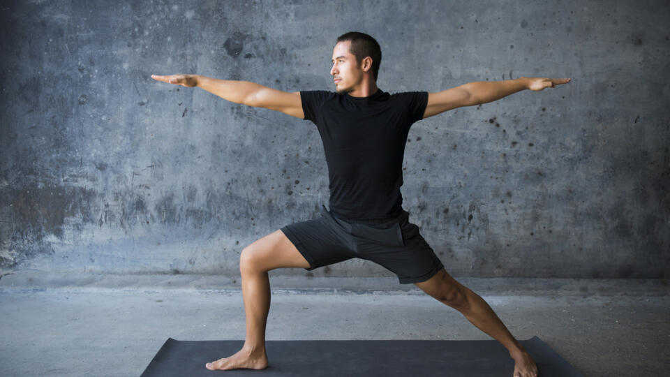 Man practicing yoga against a urban background