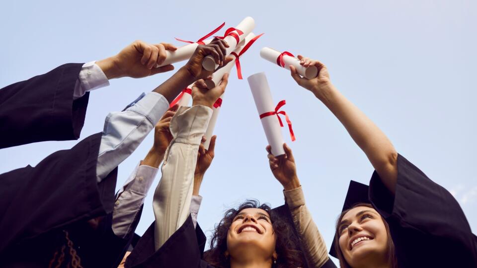 Happy,Graduate,Students,Standing,In,A,Circle,In,Black,Robes