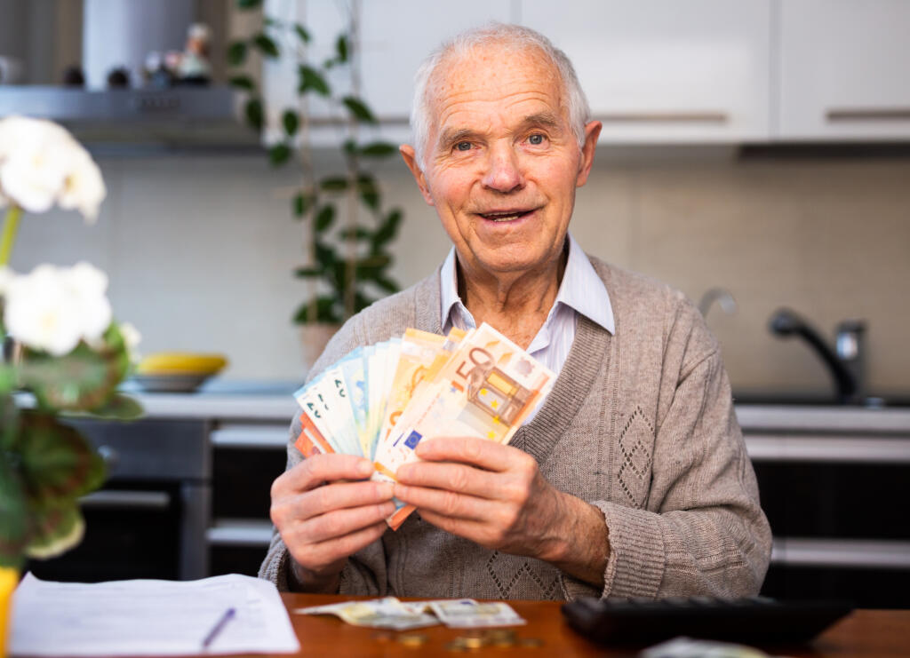 Elderly,Contented,Senor,Holding,Fan,Of,Euro,Banknotes