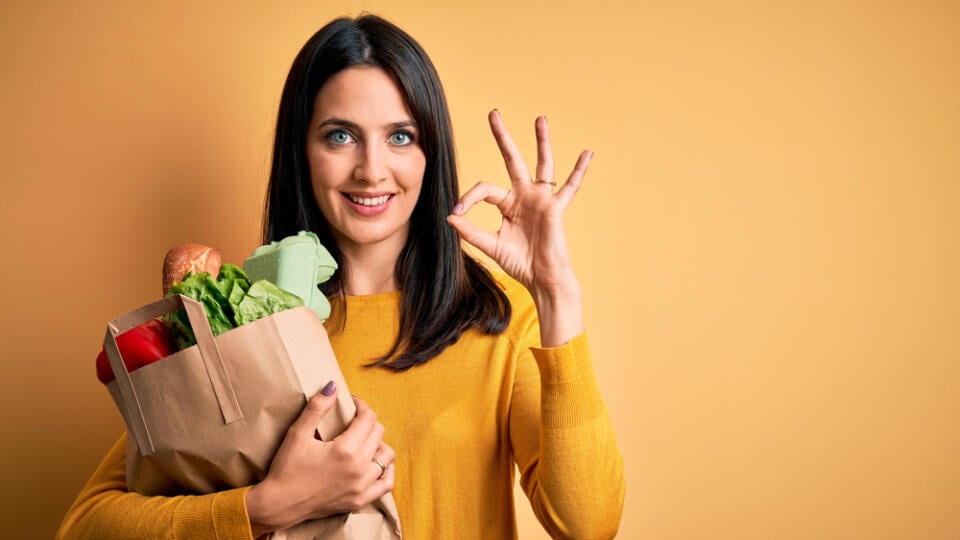 Young,Brunette,Woman,With,Blue,Eyes,Holding,Healthy,Groceries,In