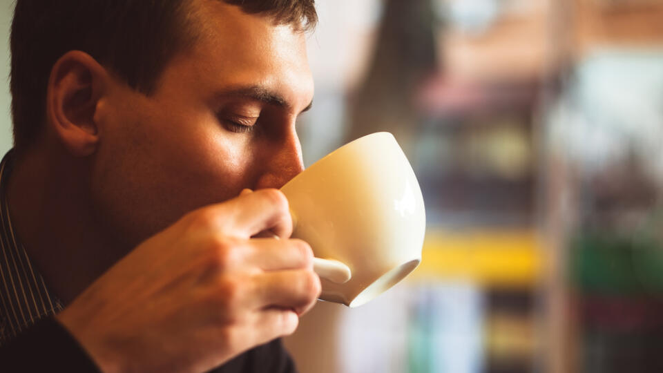 Young,Man,Drinks,Coffee,On,The,Street.,Man,Drinks,Coffee.