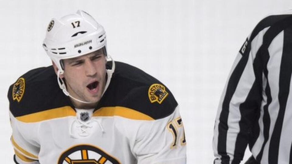 Boston Bruins' Milan Lucic, left, reacts as he is escorted off the ice by linesman Michel Cormier after receiving a penalty near the end of an NHL hockey game against the Montreal Canadiens, Thursday, Oct. 16, 2014, in Montreal. The Canadiens won 6-4. (AP Photo/The Canadian Press, Paul Chiasson)