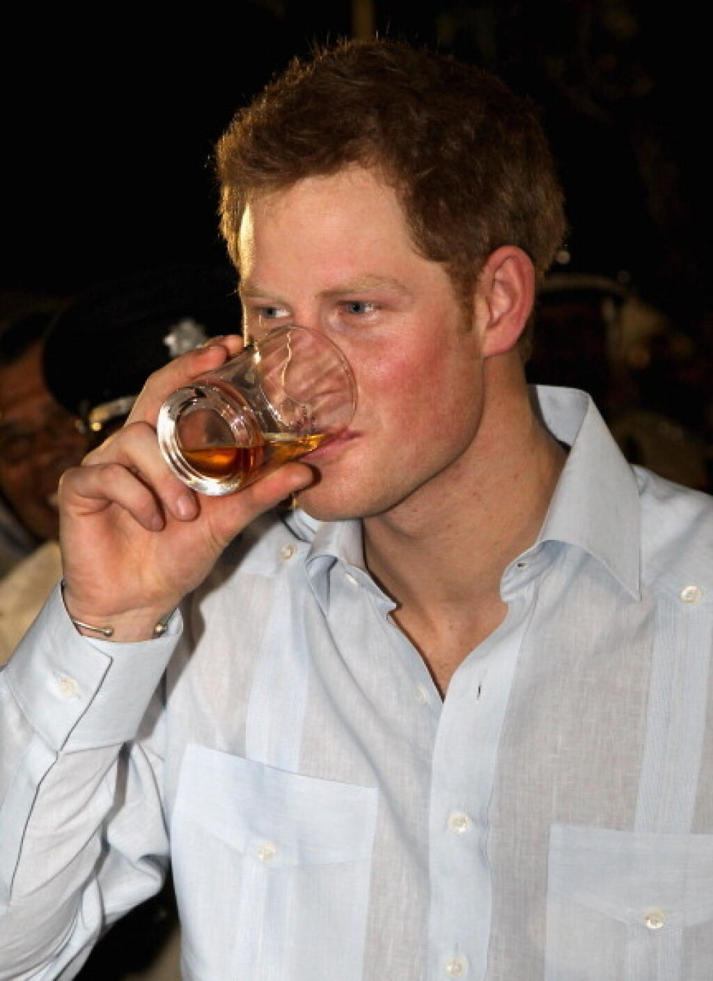 BELIZE CITY, BELIZE - MARCH 02: Prince Harry enjoys a drink as he attends a Jubilee Block Party on March 2, 2012 in Belmopan, Belize. The Prince is visiting Belize as part of a Diamond Jubilee tour where he will be visiting Belize, the Bahamas, Jamaica and Brazil as a representative of Queen Elizabeth II. Belize is a Commonwealth realm with a population of around 350,000. With the second longest barrier reef in the world and with much of the country covered in tropical jungle with a diversity o