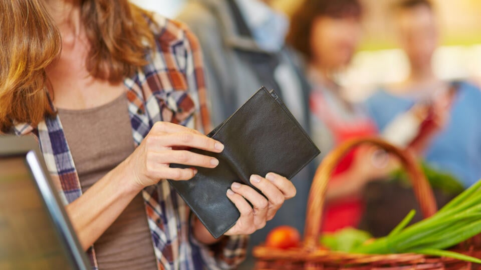 Hand,Of,A,Woman,Looking,For,Money,In,Wallet,At