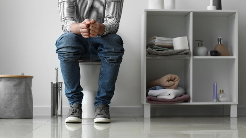 Man,Sitting,On,Toilet,Bowl,At,Home