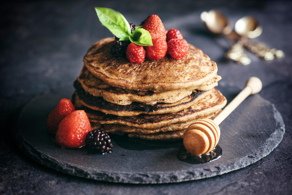 Buckwheat pancakes with berry fruit and honey.Selective focus