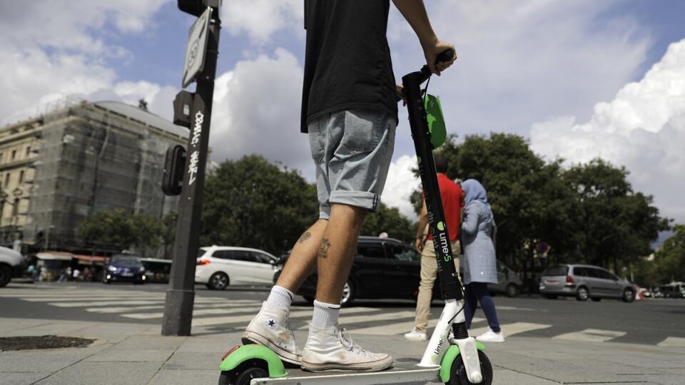 A man rides an electric scooter in Paris, Monday, Aug. 12, 2019. The French government is meeting with people who've been injured by electric scooters as it readies restrictions on vehicles that are transforming the Paris cityscape. The Transport Ministry says Monday's closed-door meeting is part of consultations aimed at limiting scooter speeds and where users can ride and park them. (AP Photo/Lewis Joly)