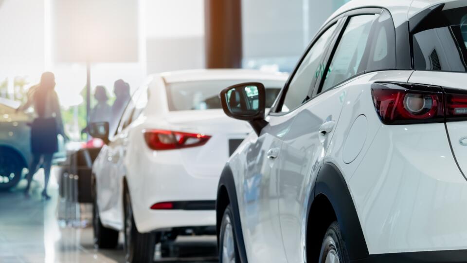 Rearview,White,Suv,Car,In,Modern,Luxury,Showroom,On,Blur