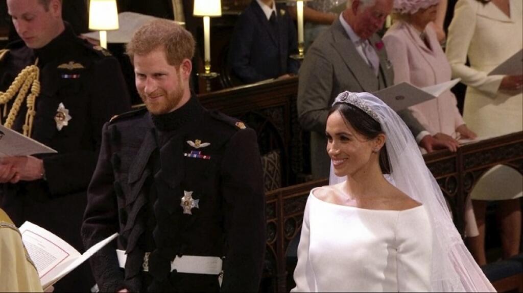 In this frame from video, Britain's Prince Harry and Meghan Markle stand during their wedding ceremony at St. George's Chapel in Windsor Castle in Windsor, near London, England, Saturday, May 19, 2018. (UK Pool/Sky News via AP)