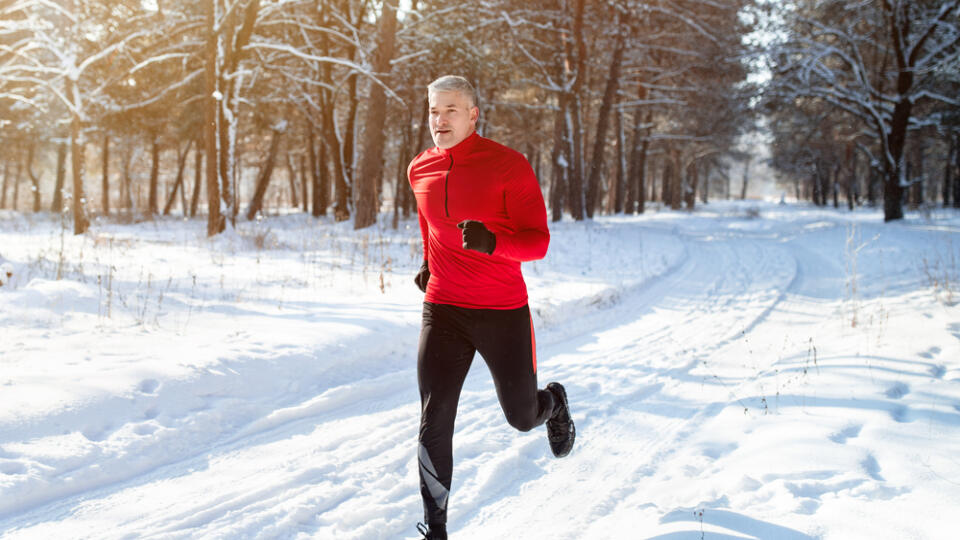 Athletic,Mature,Man,In,Sportswear,Jogging,At,Snowy,Winter,Park.