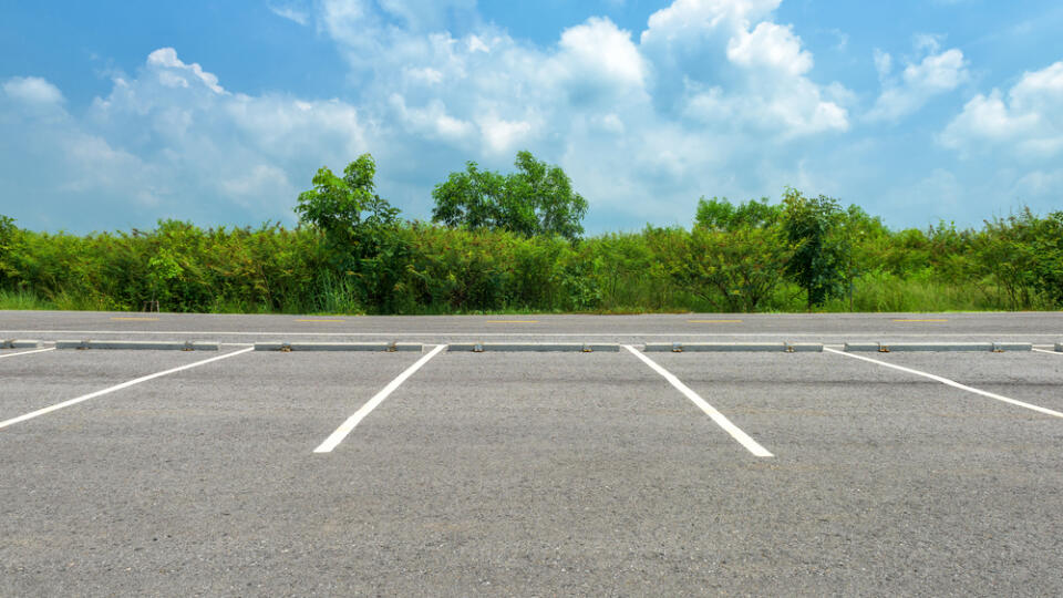 Empty,Parking,Lot,On,Blue,Sky,Background