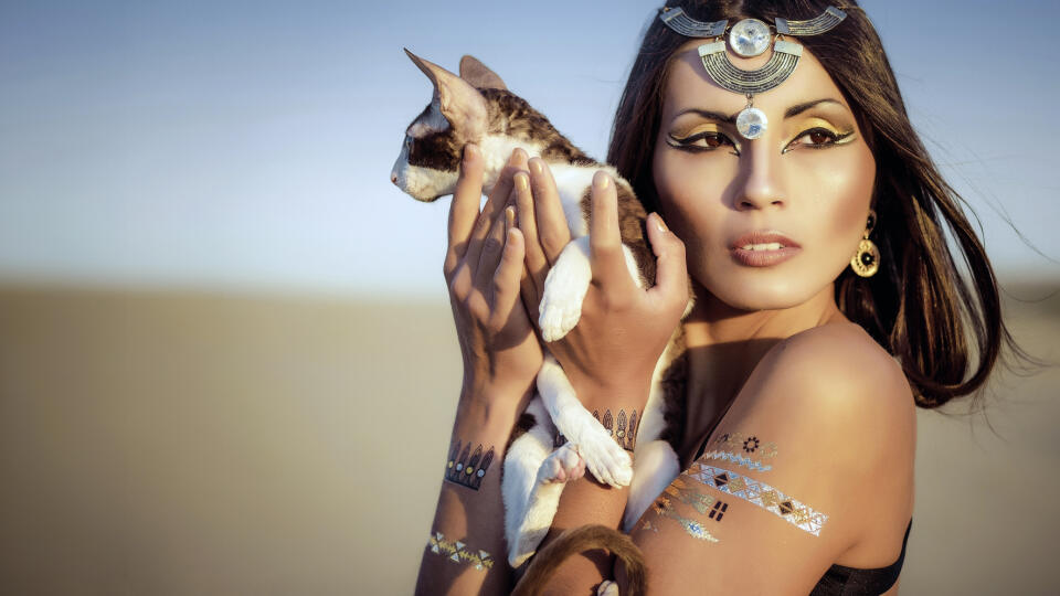 Glamorous portrait of beautiful sexy brunette woman model with Flash Tattoo. Cleopatra. Shooting outdoors in the style of ancient Egypt.
