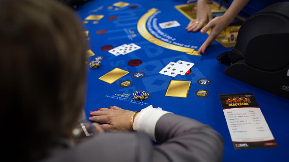 An attendee plays at a Blackjack table at the Global Gaming Expo (G2E) inside the Venetian Macau resort and casino, operated by Sands China Ltd., a unit of Las Vegas Sands Corp., in Macau, China, on Tuesday, May 19, 2015. The gaming expo runs through May 21. Photographer: Billy H.C. Kwok/Bloomberg via Getty Images