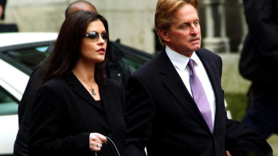 LONDON - FEBRUARY 10:  Actress Catherine Zeta-Jones (L) and her husband, actor Michael Douglas, leave the Royal Courts of Justice after testifying February 10, 2003 in London. The Welsh actress and her Oscar-winning husband are suing "Hello!" magazine for millions of pounds after it published unauthorized photos of their New York November 2000 wedding, for which they had signed an exclusive deal with rival magazine "OK."  (Photo by John Li/Getty Images)