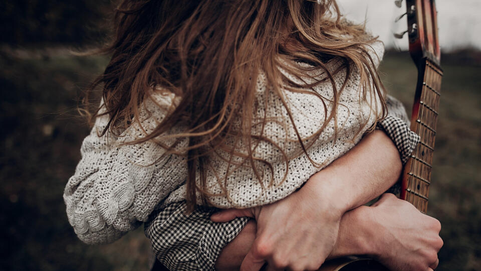 Man,With,Guitar,Hugging,His,Boho,Gypsy,Woman,Closeup,In