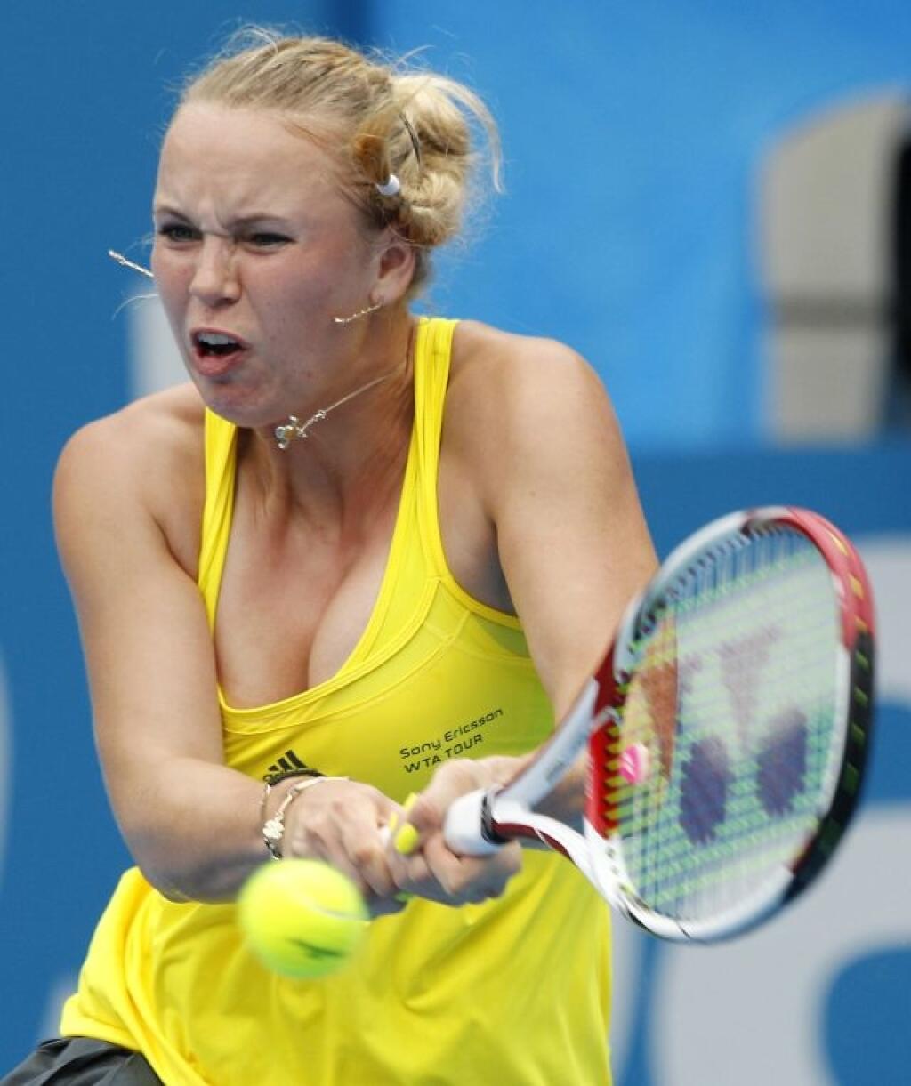 Caroline Wozniacki of Denmark plays a shot in her match against Dominika Cibulkova of Slovakia during the Sydney International Tennis Tournament in Sydney, Australia, Tuesday, Jan. 11, 2011. (AP Photo/Rob Griffith)