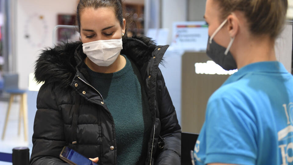 Na Slovensku platia od piatka nové pandemické opatrenia. Pre osoby, ktoré prekonali ochorenie COVID-19 v posledných 180 dňoch a pre očkovaných sa môžu otvoriť všetky obchodné prevádzky a niektoré služby. Na snímke kontrola covid pasov pred vstupom do predajne v Košiciach 10. decembra 2021. FOTO TASR – František Iván