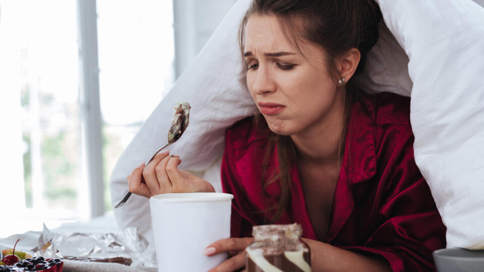 Stressed,Woman.,Stressed,Crying,Woman,Hiding,Under,Coverlet,While,Eating