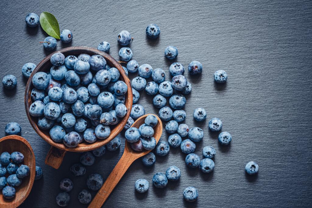 The,Blueberries,In,A,Wooden,Bowl,And,Spoon,And,Scattered