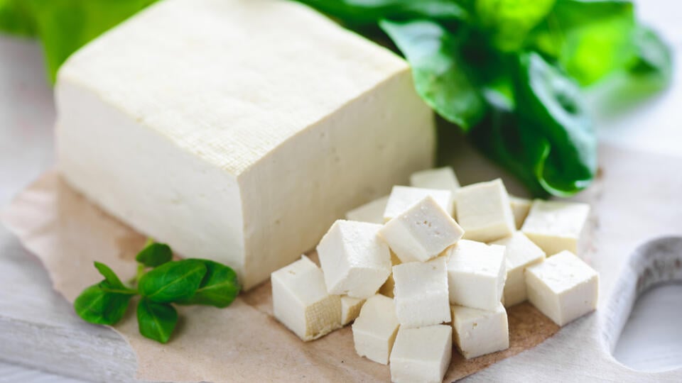 Soy,Cheese,Tofu,Diced,On,A,Cutting,Board,,Basil,Closeup