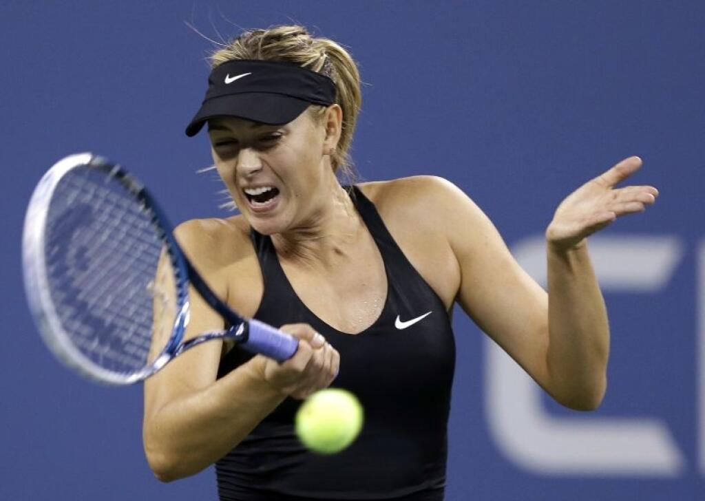 Maria Sharapova, of Russia, returns a shot to Maria Kirilenko, of Russia, during the opening round of the U.S. Open tennis tournament Monday, Aug. 25, 2014, in New York. (AP Photo/Darron Cummings)