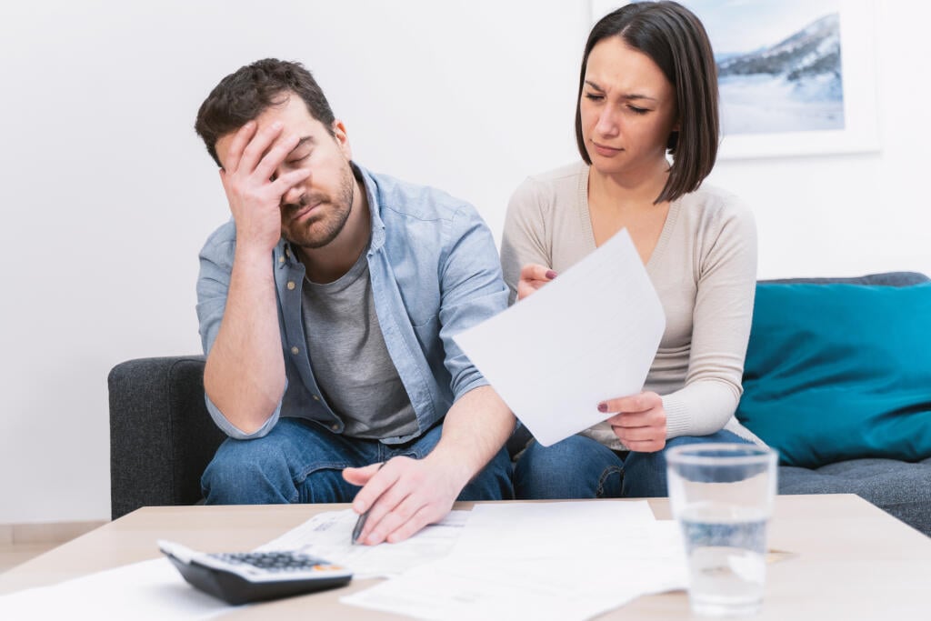 Worried,Couple,Portrait,Analyzing,Family,Bills,At,Home