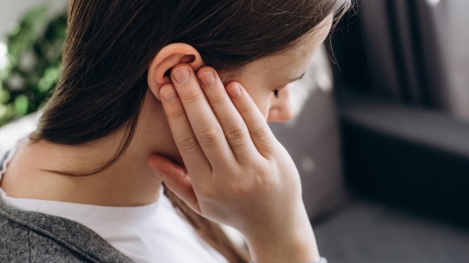 Close,Up,Of,Young,Brunette,Female,Holding,Painful,Ear,,Suddenly