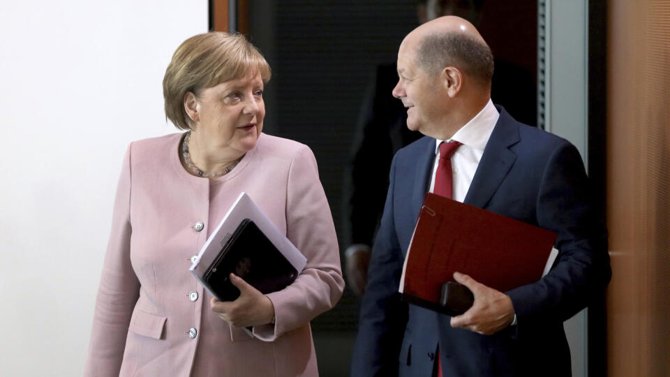 German Chancellor Angela Merkel, left, and German Finance Minister Olaf Scholz, right, arrive for the weekly cabinet meeting at the chancellery in Berlin, Germany, Thursday, June 6, 2019. (AP Photo/Michael Sohn)