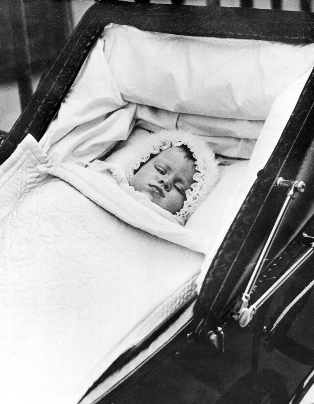 This rare photograph of Princess Elizabeth was made on her first outing, October 9, 1926. She was born on April 21, 1926 to the Duke and Duchess of York, at Glamis Castle in Scotland. At the time of her birth, her grandfather was King George V of Great Britain. Her uncle, the Prince of Wales, was the Heir Apparent to the throne.